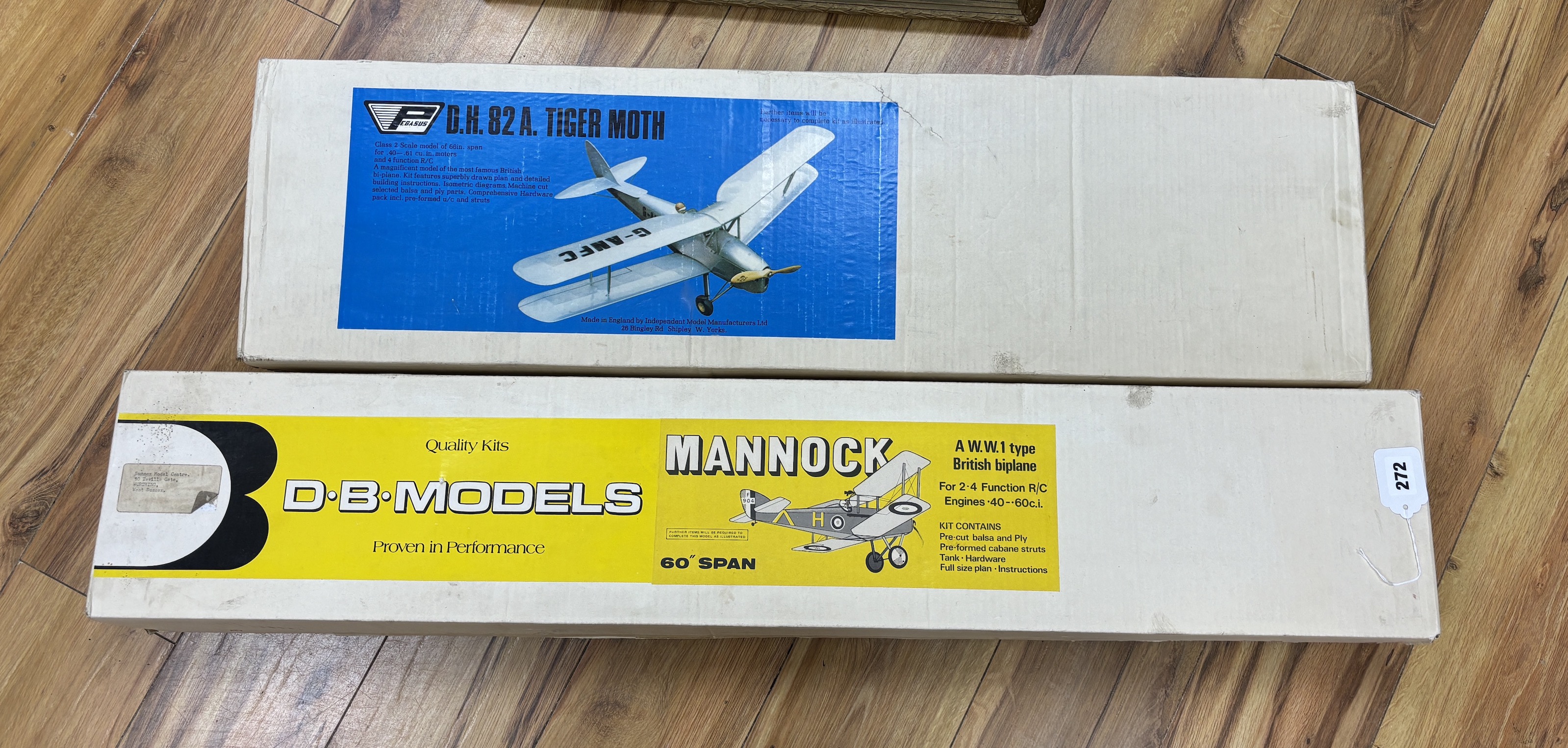 Two large wooden aircraft kits; a D.B. models Mannock and a Pegasus D.H. 82A Tiger Moth, longest box 106cm